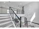 Elegant staircase with metal railings, modern chandelier, and open view to living room below at 2140 Catalina Dr, Clearwater, FL 33764