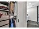Spacious walk-in closet with custom shelving and hanging space, located adjacent to a modern bathroom at 2140 Catalina Dr, Clearwater, FL 33764