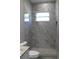 Modern bathroom features a shower with stone floors and tiled walls, plus a window at 2211 E 28Th Ave, Tampa, FL 33605