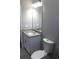 Bathroom with granite countertop vanity, overhead lighting, and a standard toilet at 2211 E 28Th Ave, Tampa, FL 33605