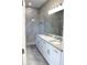 Bathroom featuring a double vanity with granite countertop and large marble tiled shower at 2211 E 28Th Ave, Tampa, FL 33605