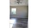 Bright bedroom featuring hard surface flooring, a tray ceiling with fan, and a window at 2211 E 28Th Ave, Tampa, FL 33605