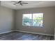 Bedroom with large window, luxury vinyl plank flooring and ceiling fan at 2211 E 28Th Ave, Tampa, FL 33605