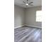 Bedroom with hard surface floors, a ceiling fan, a window, and neutral-colored walls at 2211 E 28Th Ave, Tampa, FL 33605