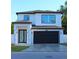 Inviting exterior view of a modern two-story home with a dark garage door and stylish front entrance at 2211 E 28Th Ave, Tampa, FL 33605