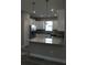 Modern kitchen with white cabinetry, granite countertops, stainless steel appliances, and stylish pendant lighting at 2211 E 28Th Ave, Tampa, FL 33605