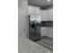 Kitchen featuring a stainless steel refrigerator, granite countertops, and white cabinets at 2211 E 28Th Ave, Tampa, FL 33605