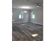 Open-concept living room with two windows and a ceiling fan at 2211 E 28Th Ave, Tampa, FL 33605