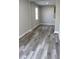 Living room with luxury vinyl plank flooring, large window and freshly painted neutral walls at 2211 E 28Th Ave, Tampa, FL 33605