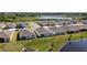 Stunning aerial view of a residential community featuring well-maintained homes, a tranquil pond, and lush landscaping at 23231 Scaglione Dr, Lutz, FL 33549