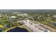 Aerial view of a community near a commercial area, showcasing easy access to shopping and a serene pond nearby at 23231 Scaglione Dr, Lutz, FL 33549