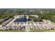 Expansive aerial community view, surrounded by natural beauty, featuring a pond and convenient street access at 23231 Scaglione Dr, Lutz, FL 33549