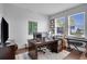 Well-lit home office features a large desk, comfortable chair, and bright windows offering a pleasant workspace at 23231 Scaglione Dr, Lutz, FL 33549