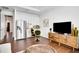 Bright living room includes seating and a kitchen area with stainless steel appliances at 23231 Scaglione Dr, Lutz, FL 33549