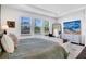 Bright main bedroom boasts lots of natural light from windows and has a seating area with a white couch at 23231 Scaglione Dr, Lutz, FL 33549