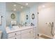 Elegant bathroom with patterned wallpaper, shower, and vanity with ample counter space at 2401 S Ardson Pl # 503, Tampa, FL 33629