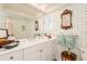 Charming bathroom featuring a white vanity, decorative wallpaper, and ample counter space at 2401 S Ardson Pl # 503, Tampa, FL 33629