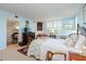 Bright bedroom featuring shuttered windows, dresser and a connected office space at 2401 S Ardson Pl # 503, Tampa, FL 33629