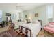 Bright bedroom with two beds, ceiling fan, shuttered windows, and stylish antique furniture at 2401 S Ardson Pl # 503, Tampa, FL 33629