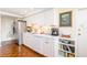 A compact kitchen features white cabinetry, stainless steel appliances, and hardwood floors at 2401 S Ardson Pl # 503, Tampa, FL 33629