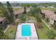 Aerial view of apartments with a community pool, green spaces, and parking at 2500 Harn Blvd # B11, Clearwater, FL 33764