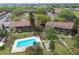 Aerial view of apartments with a community pool, green spaces, and parking at 2500 Harn Blvd # B11, Clearwater, FL 33764