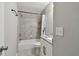 Bathroom featuring shower over tub, light gray tiling, and white vanity with granite countertop at 2500 Harn Blvd # B11, Clearwater, FL 33764