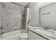 Bathroom featuring shower over tub, light gray tiling, and white vanity with granite countertop at 2500 Harn Blvd # B11, Clearwater, FL 33764