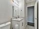 Bathroom featuring white vanity with granite countertop and large mirror at 2500 Harn Blvd # B11, Clearwater, FL 33764
