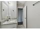 Bathroom with granite countertop, white cabinets, and an open doorway at 2500 Harn Blvd # B11, Clearwater, FL 33764