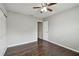 Bedroom featuring wooden floors, ceiling fan, closet with sliding doors, and a doorway to hall at 2500 Harn Blvd # B11, Clearwater, FL 33764