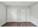 This bedroom has hardwood floors and a closet with sliding doors at 2500 Harn Blvd # B11, Clearwater, FL 33764