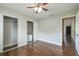 Bedroom featuring wooden floors, ceiling fan, and closet with sliding doors at 2500 Harn Blvd # B11, Clearwater, FL 33764