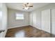 Bedroom featuring wooden floors, ceiling fan, and closet with sliding doors at 2500 Harn Blvd # B11, Clearwater, FL 33764