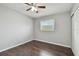 This bedroom has hardwood floors, a ceiling fan, a window, and a closet at 2500 Harn Blvd # B11, Clearwater, FL 33764