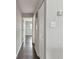 Hallway with hardwood floors and white doors provides easy access to bedrooms at 2500 Harn Blvd # B11, Clearwater, FL 33764