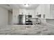 Updated kitchen featuring stainless steel appliances, white cabinets, and granite countertops at 2500 Harn Blvd # B11, Clearwater, FL 33764