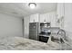 Contemporary kitchen with white cabinets, stainless steel appliances, and granite countertops at 2500 Harn Blvd # B11, Clearwater, FL 33764