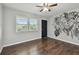 Welcoming living space features a bright window, dark accent door, and artistic botanical wall art at 2500 Harn Blvd # B11, Clearwater, FL 33764