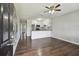 Bright living room with hardwood floors, ceiling fan, and modern black-and-white mural on the wall at 2500 Harn Blvd # B11, Clearwater, FL 33764