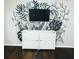 Living room with modern shelving, a flat-screen TV, and a unique botanical mural wall at 2500 Harn Blvd # B11, Clearwater, FL 33764