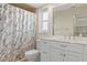 Bathroom featuring a shower, marble-top vanity, and neutral tile flooring at 2692 Royal Ridge Dr, Spring Hill, FL 34606