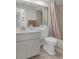 Cozy bathroom features a shower-tub combo, classic white tiling, and a functional single sink vanity at 2692 Royal Ridge Dr, Spring Hill, FL 34606