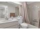 Cozy bathroom features a shower-tub combo, classic white tiling, and a functional single sink vanity at 2692 Royal Ridge Dr, Spring Hill, FL 34606