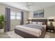 This staged bedroom features calming gray tones, soft textures, and a plush rug for a serene retreat at 2692 Royal Ridge Dr, Spring Hill, FL 34606