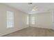 Bedroom featuring wood-look floors, three windows for natural light, and a neutral wall color at 2692 Royal Ridge Dr, Spring Hill, FL 34606