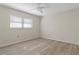 Empty bedroom with natural light, wood-look floors, and neutral paint at 2692 Royal Ridge Dr, Spring Hill, FL 34606