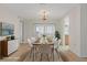 Dining room showcasing a chandelier, modern table setting, and sliding doors to sunroom at 2692 Royal Ridge Dr, Spring Hill, FL 34606
