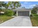 Charming home with a two-car garage, palm tree and well-maintained lawn at 2692 Royal Ridge Dr, Spring Hill, FL 34606