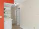Hallway featuring wood-look floors, neutral wall color, and access to the kitchen and other areas at 2692 Royal Ridge Dr, Spring Hill, FL 34606
